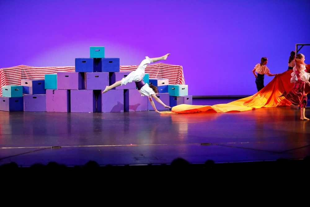 Dance Creations recital - dance photography.  Doing the splits on the see-saw.
