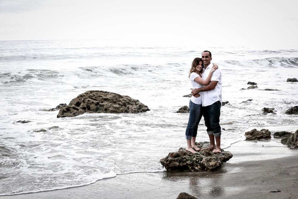 Marshall and Rachel in the surf for engagement photos Beach Engagement photography.jpg