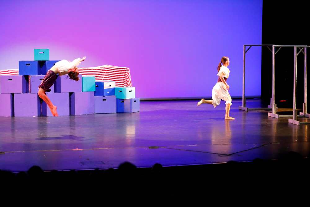 Dance Creations recital - dance photography.  Doing the splits on the see-saw.