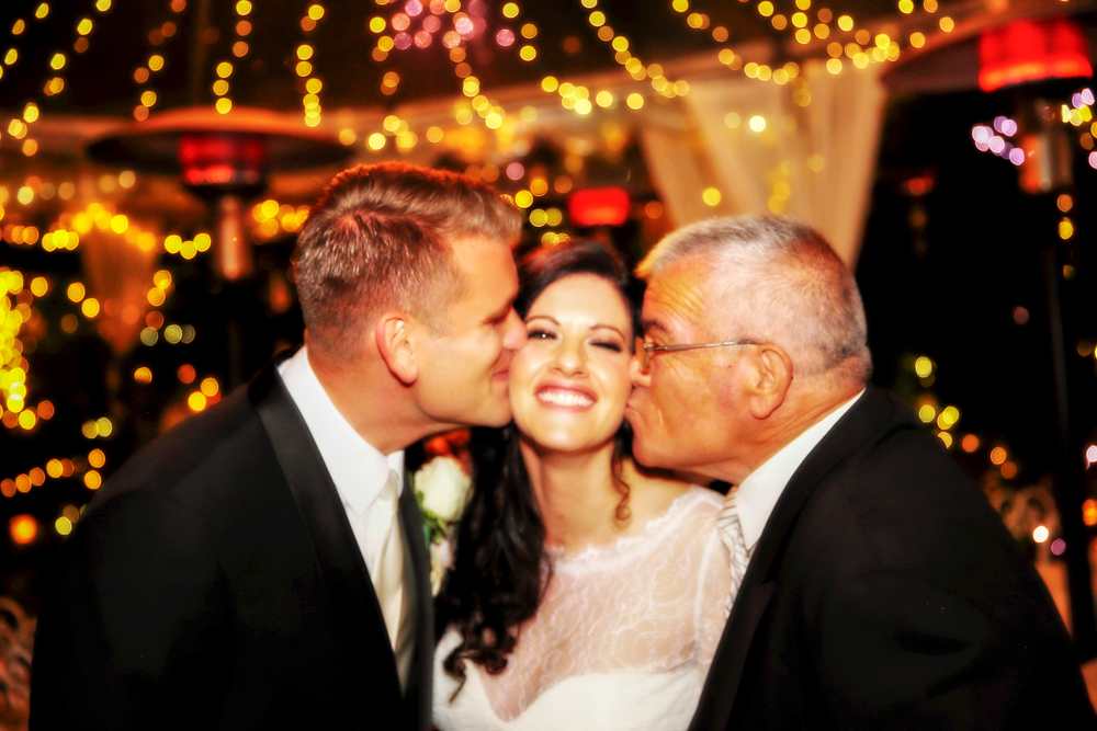 Lora, our beautiful bride, gets smooched. LoraEmanBest00000231.jpg