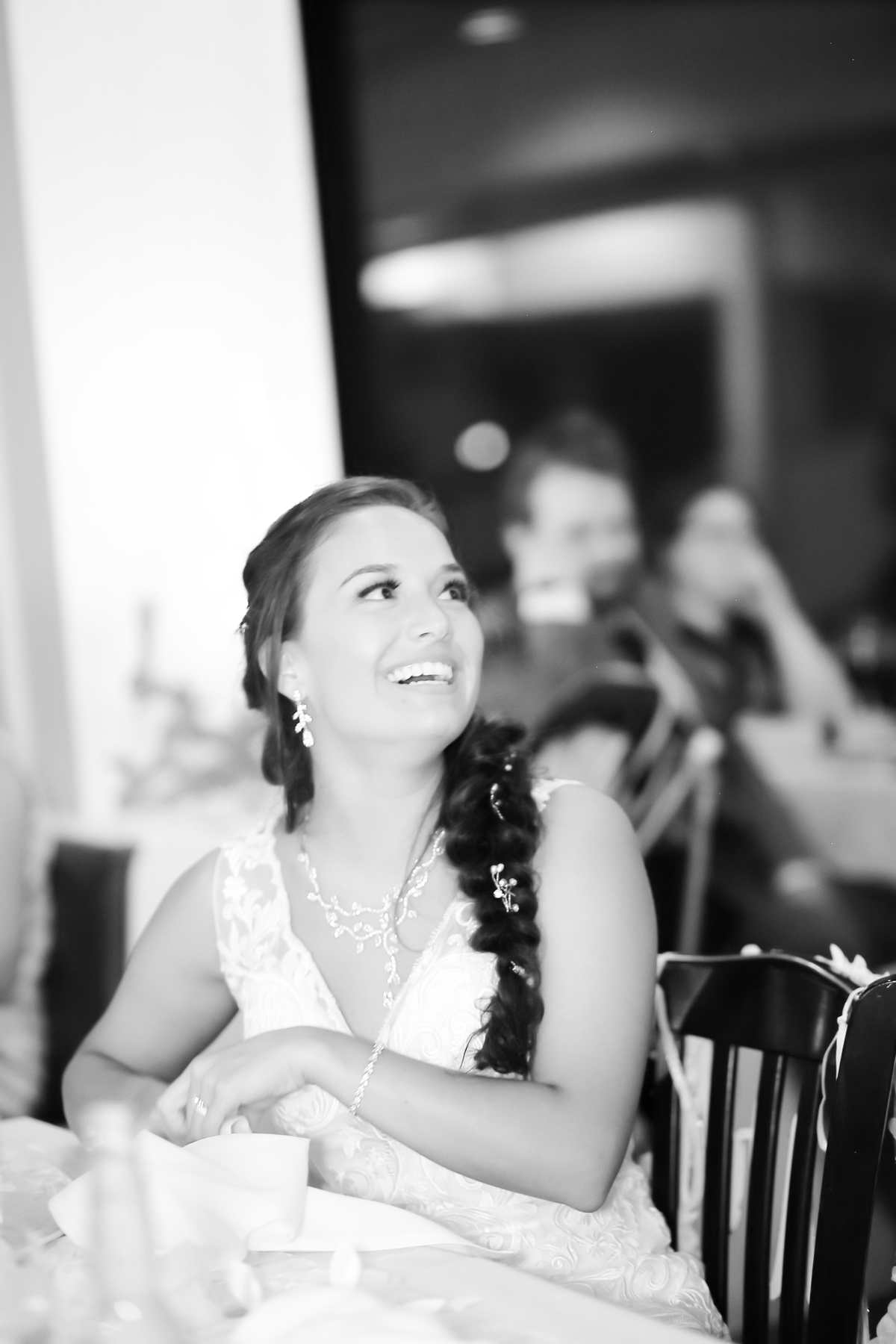 Bride enjoying speeches at the wedding Wedding reception