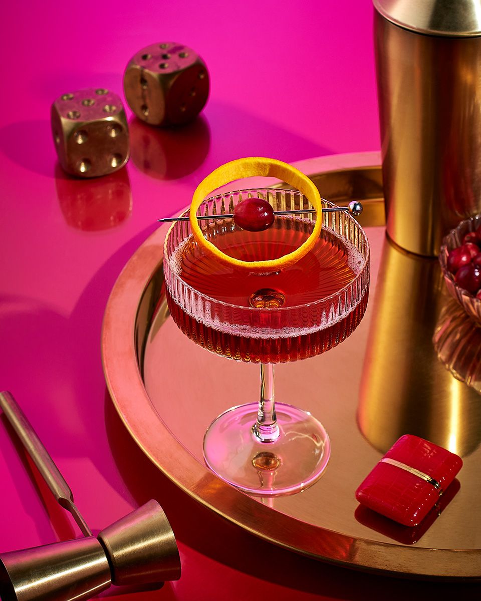 Commercial beverage photography of a cranberry orange cocktail featuring fresh citrus and vibrant colors by Dallas photographer Rusty Bradford. Cranberry Orange Cocktail - Commercial Beverage Photography.