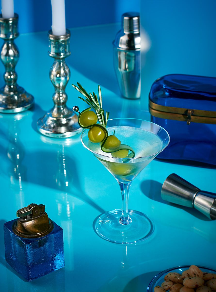 Commercial beverage photography of a cucumber rosemary martini garnished with fresh rosemary by Dallas photographer Rusty Bradford. Cucumber Rosemary Martini - Commercial Beverage Photography.
