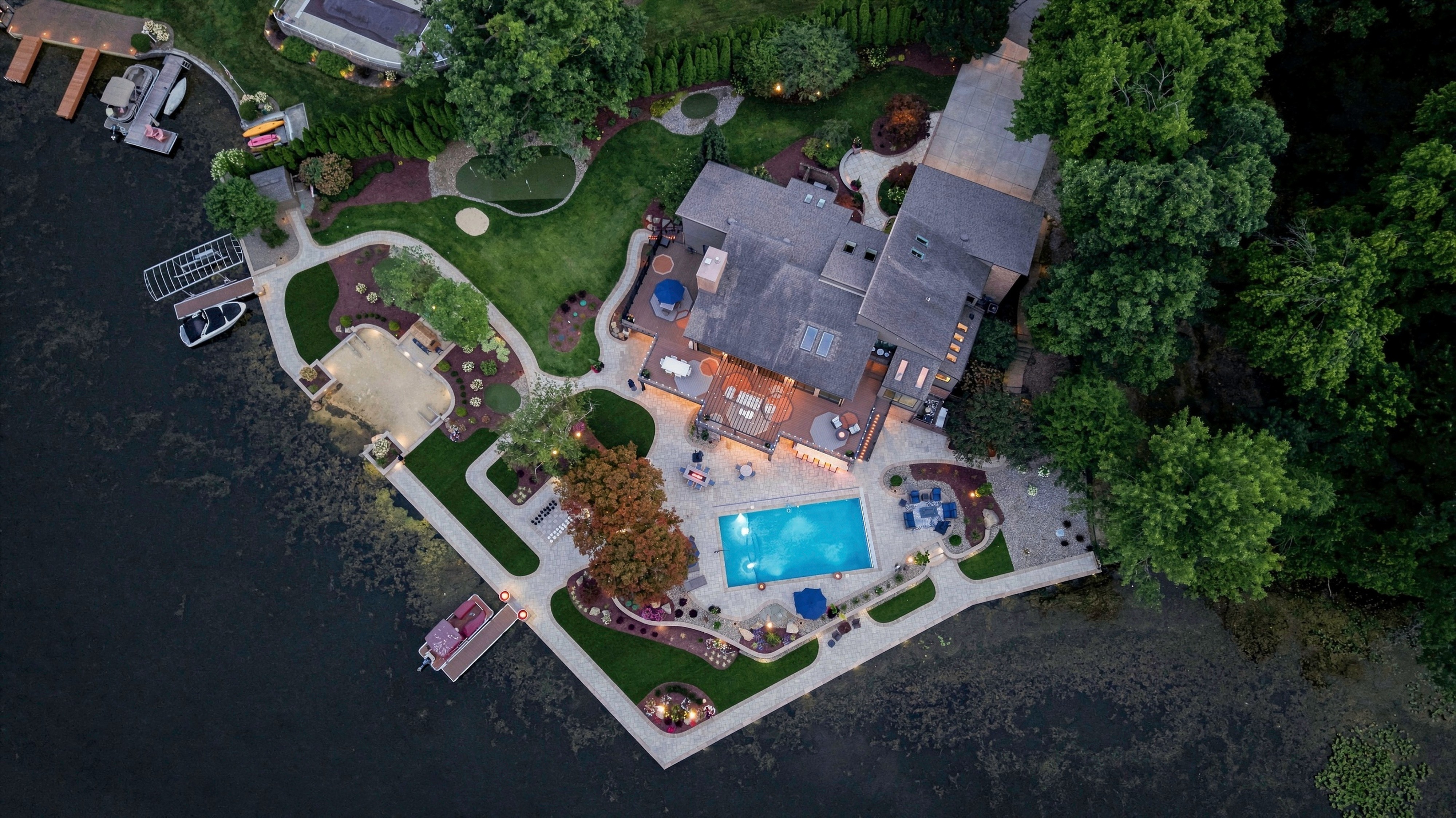 rone aerial photography showing lakefront home, dock, and water access 
