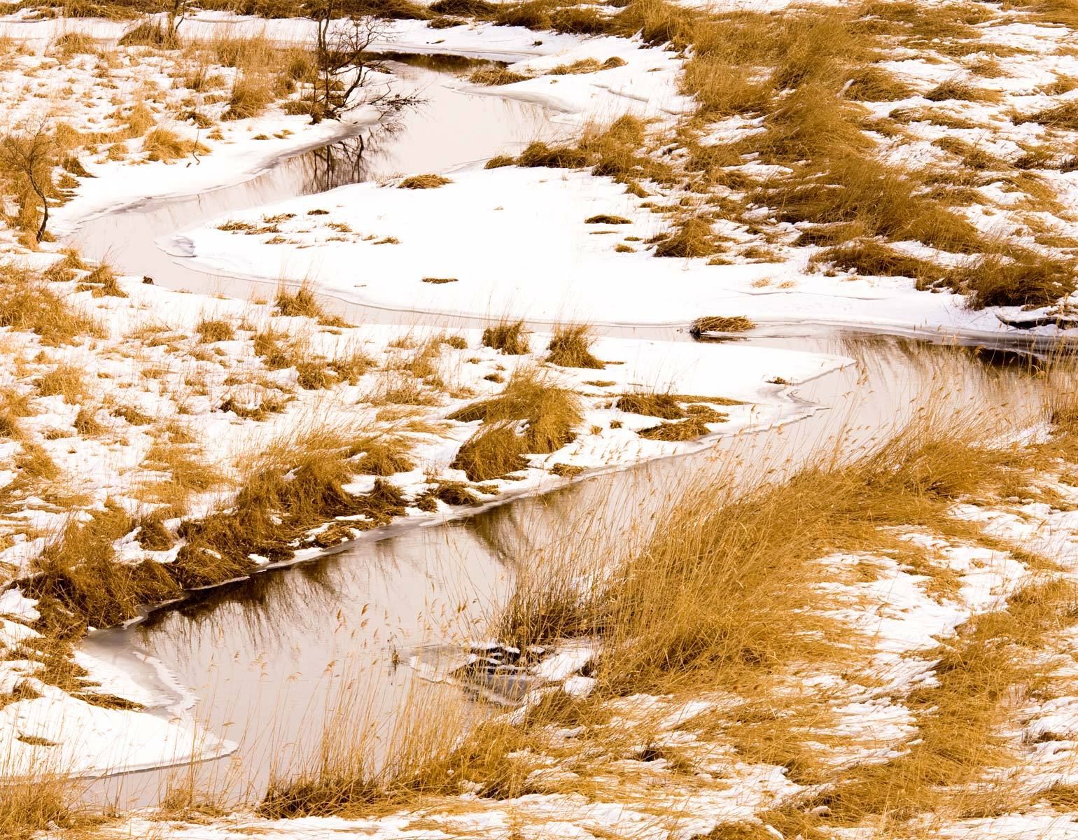 Stream winding through snow-covered Kushiro Marsh on Hokkaido Island, Japan Kushiro Marsh in Winter, Hokkaido, Japan
