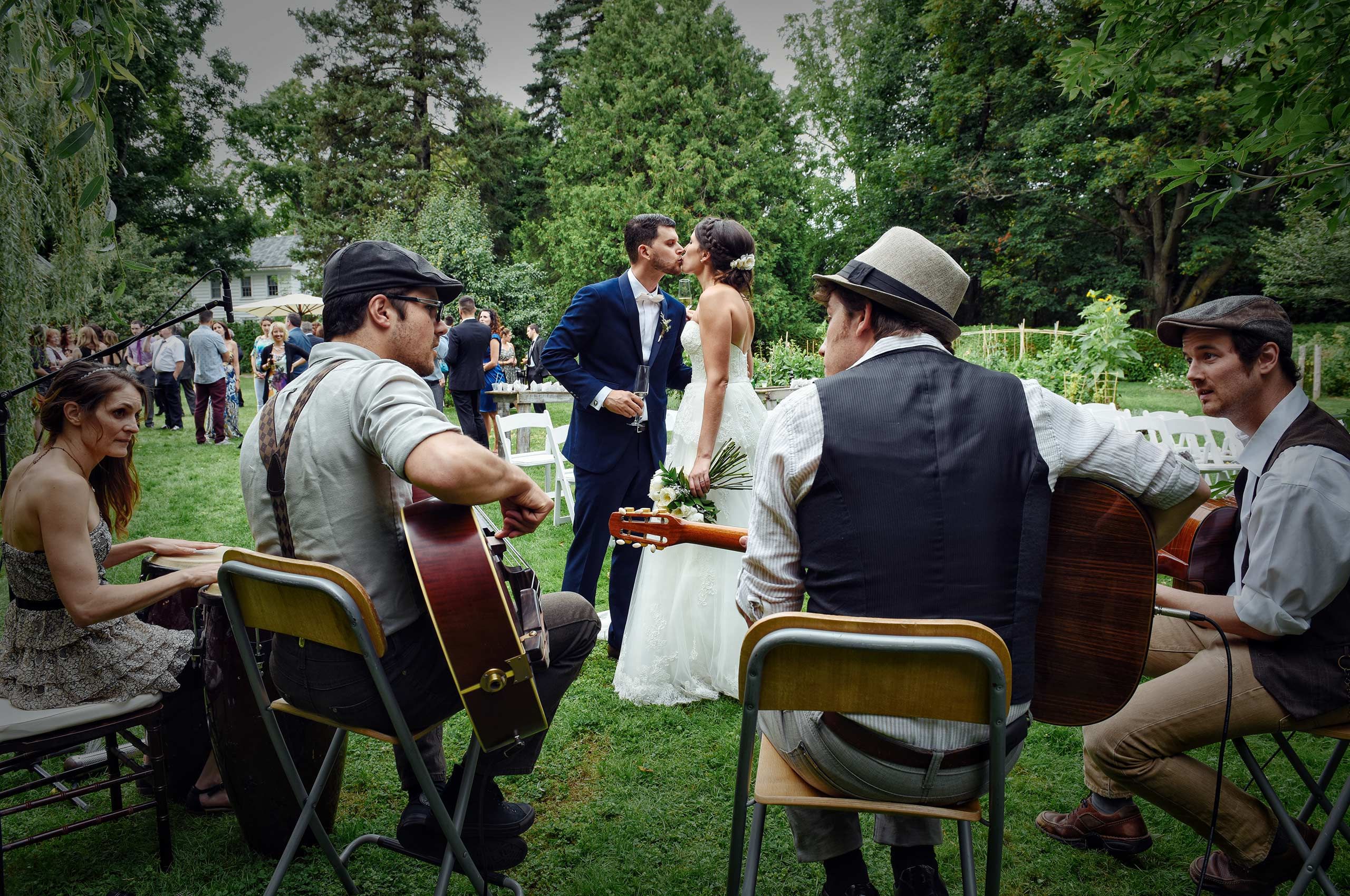 bride and groom kissing at their wedding cocktail
