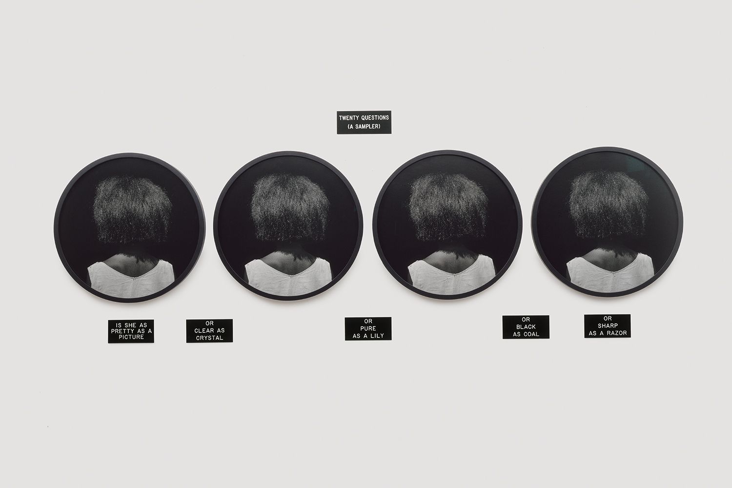 4 silver gelatin prints, 6 engraved plastic plaques - Overall: 39 1/2 x 106 1/2 x 3/8 in (83.8 x 264.8 x 1 cm), "These phrases would be of little help in determining the identity of a particular person, for each is abstracted as the image of the woman seen from the back. The work's lack of specificity, as well as its incompleteness, sets the ground for speculation." -Joan Simon Twenty Questions, 1986