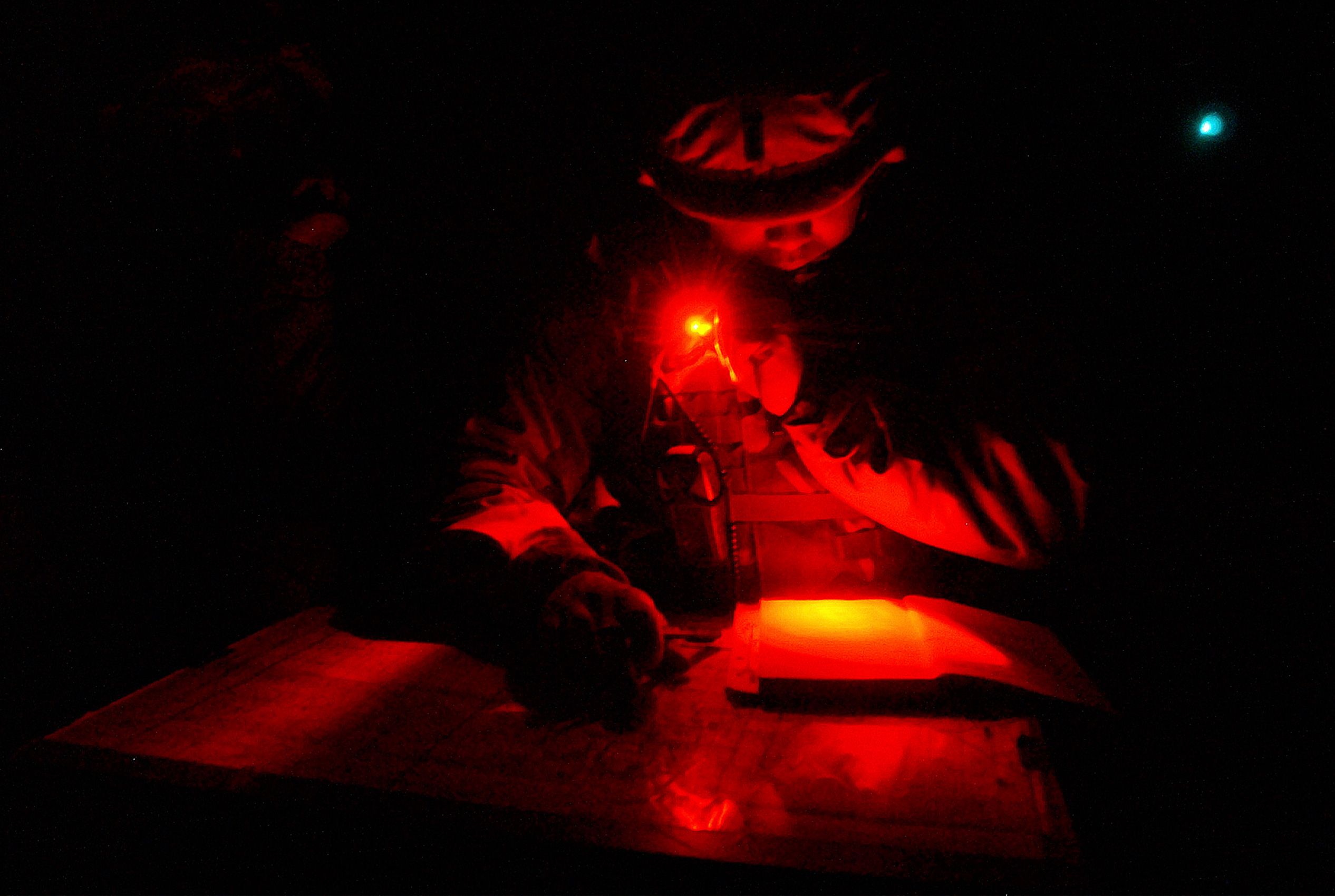 Lt. Alexander Yu of Syracuse, N.Y. reads a map in an armored personel carrier during night warfare exercises in the Kuwaiti desert south of Iraq on Wednesday, Jan. 22, 2003. Yu is a member of Task Force 1-30, Engineer Batt. 317 of the 3rd Infantry from Ft. Benning, Ga Invasion of Iraq