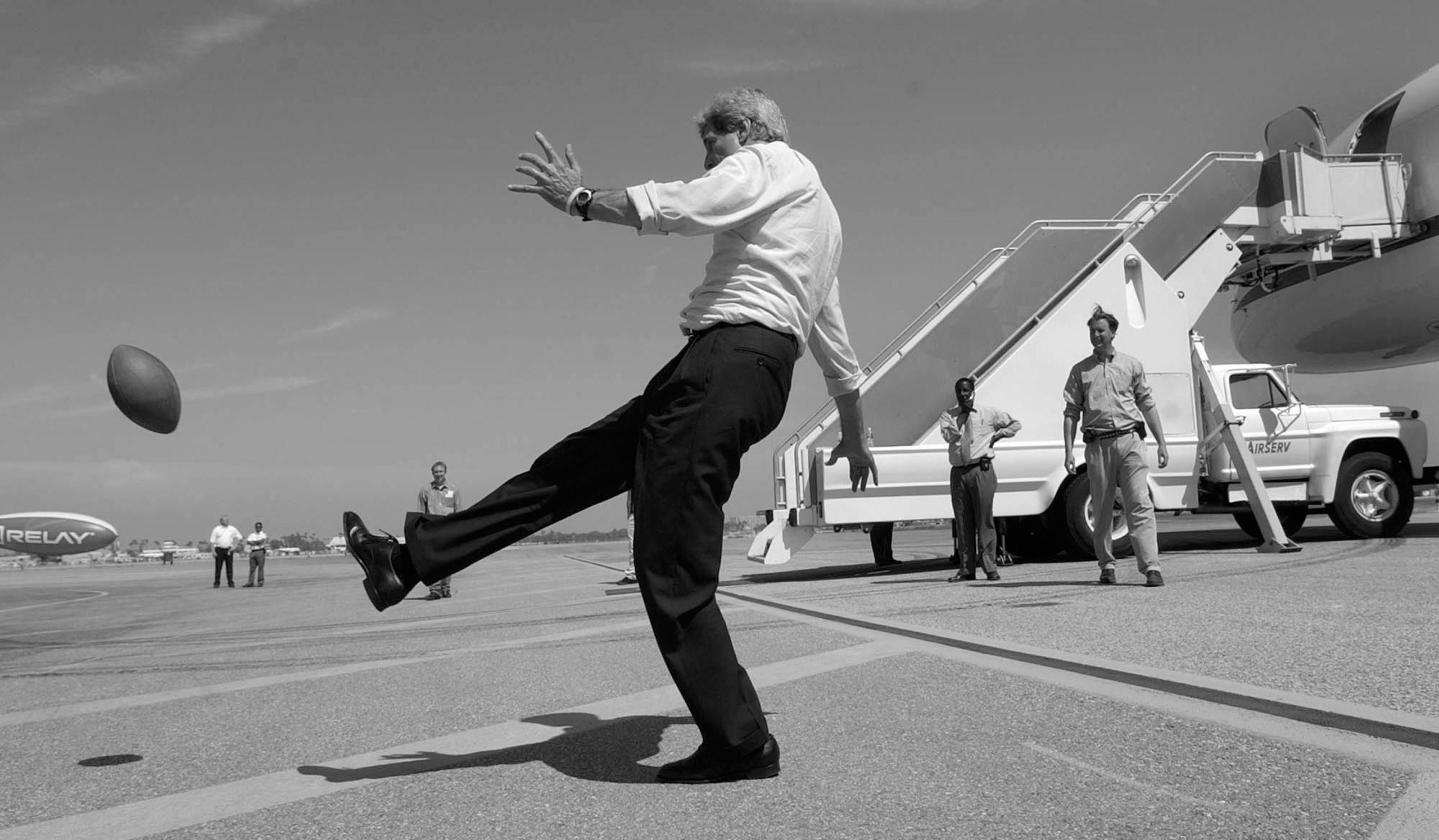 Democratic presidential nominee Sen. John Kerry, D-Mass., kicks a football on the tarmac in Long Beach, Calif. on Thursday, Aug. 12, 2004.  John Kerry Presidential Campaign 2004