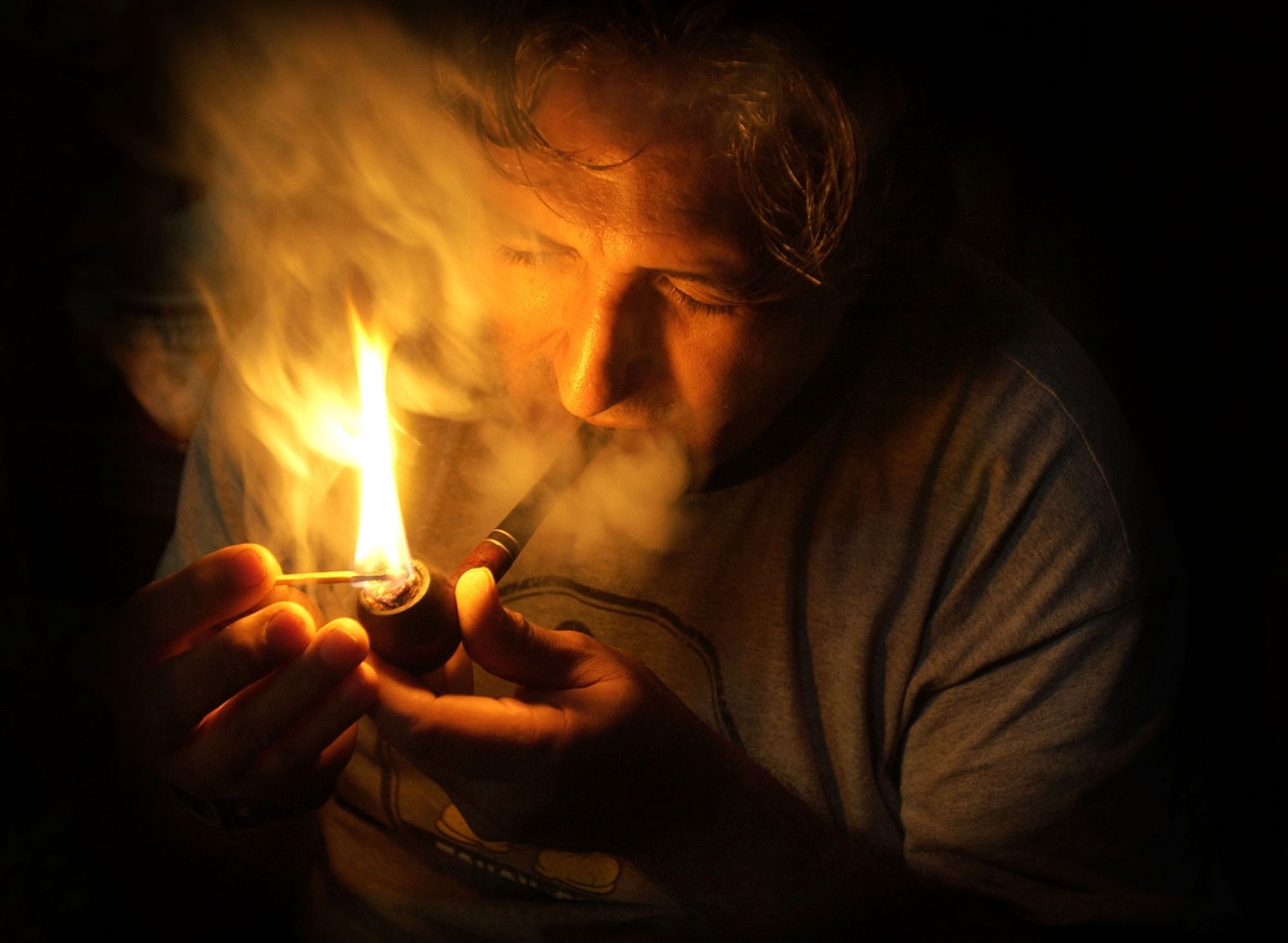 Winnemem Wintu tribal headman Mark Franco lights a pipe during a ceremony with members of his tribe in Redding, Calif., March 25, 2004.  Despite the tribe's history and traditions, the federal government says the Wintu tribe does not exist. It is not a federally recognized tribe, and thus tribal members have no protection for their sacred land, no way of ensuring their survival.  Winnemem Wintu Tribe