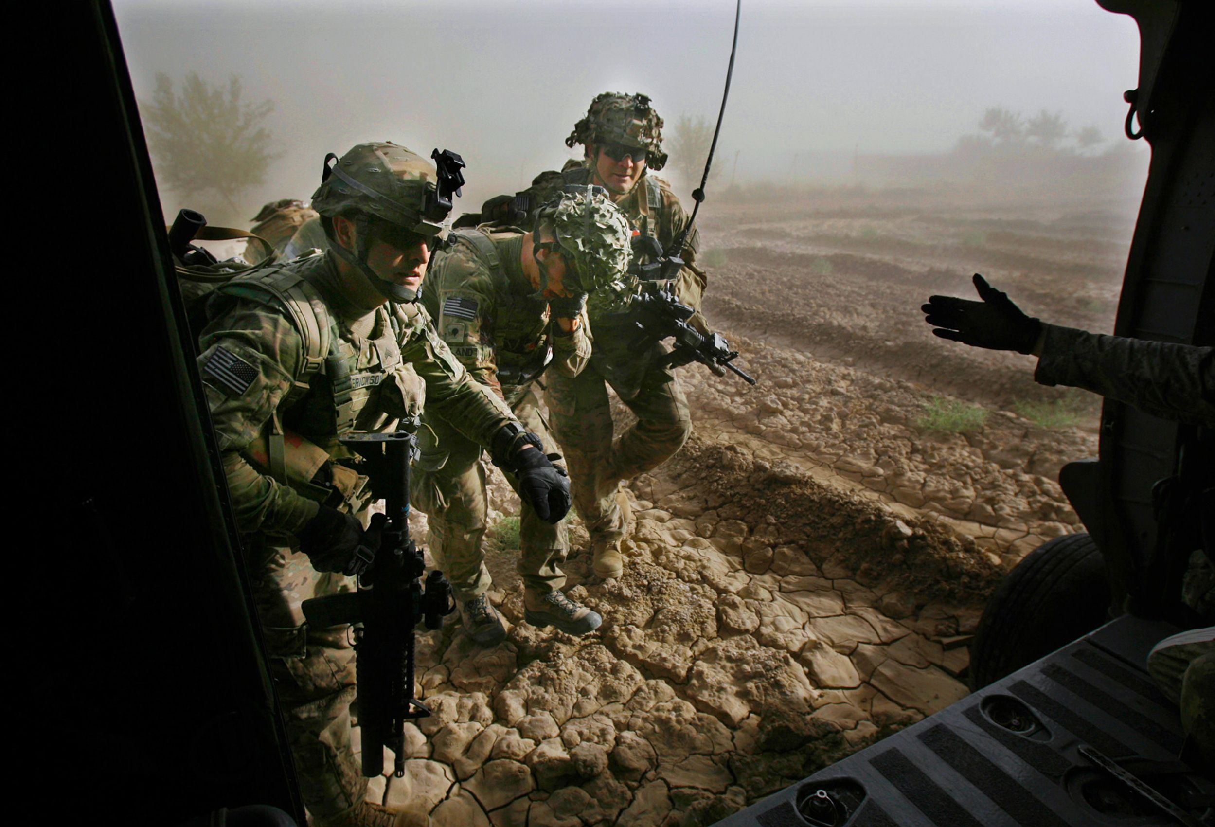Spc Mitchel (cq)Holland, of 4th Squadron, 4th Cavalry Regiment, 1st Heavy Combat Brigade, 1st Infantry Division is helped on to a medevac helicopter after being injured just east of Sangasar on June, 15, 2011 in Kandahar province Afghanistan.  MEDEVAC Afghanistan