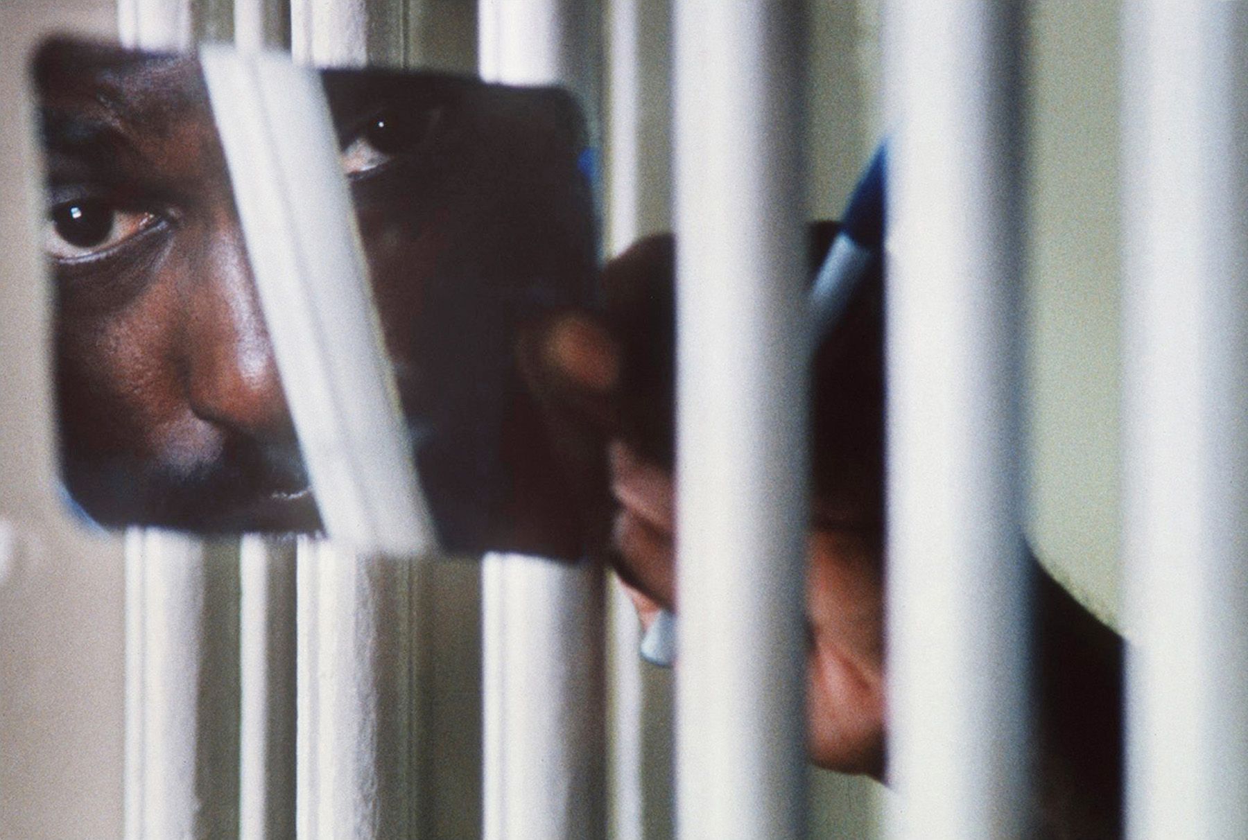 A prisoner in the maximum security section at Lansing Correctional Facility  uses a mirror to see the corridor in 1995 in Lansing, Kan.  Maximum Security Prison