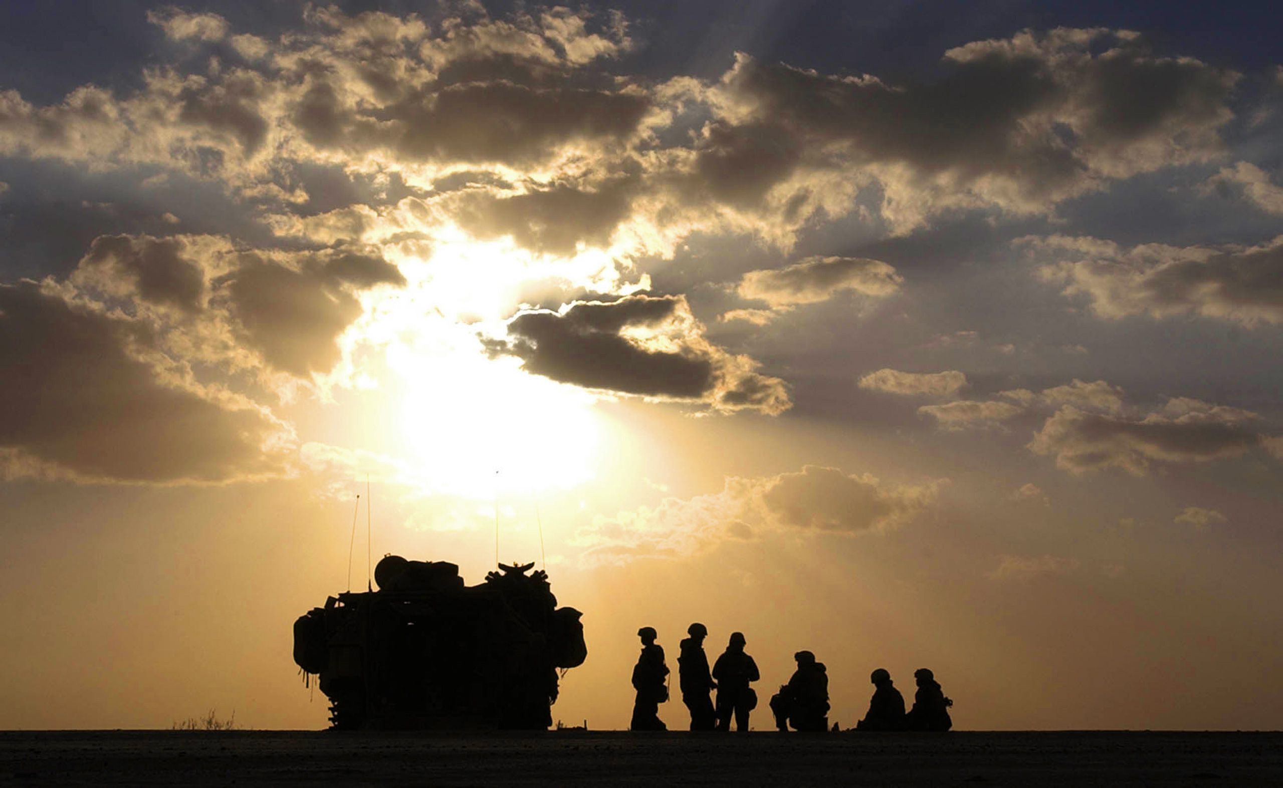 U.S. Marines with 3rd Batt., 7th Marines, 1st Marine Division, meet outside their amphibious assault vehicle on a highway south of Baghdad, Iraq on Thursday, March 27, 2003.  Invasion of Iraq