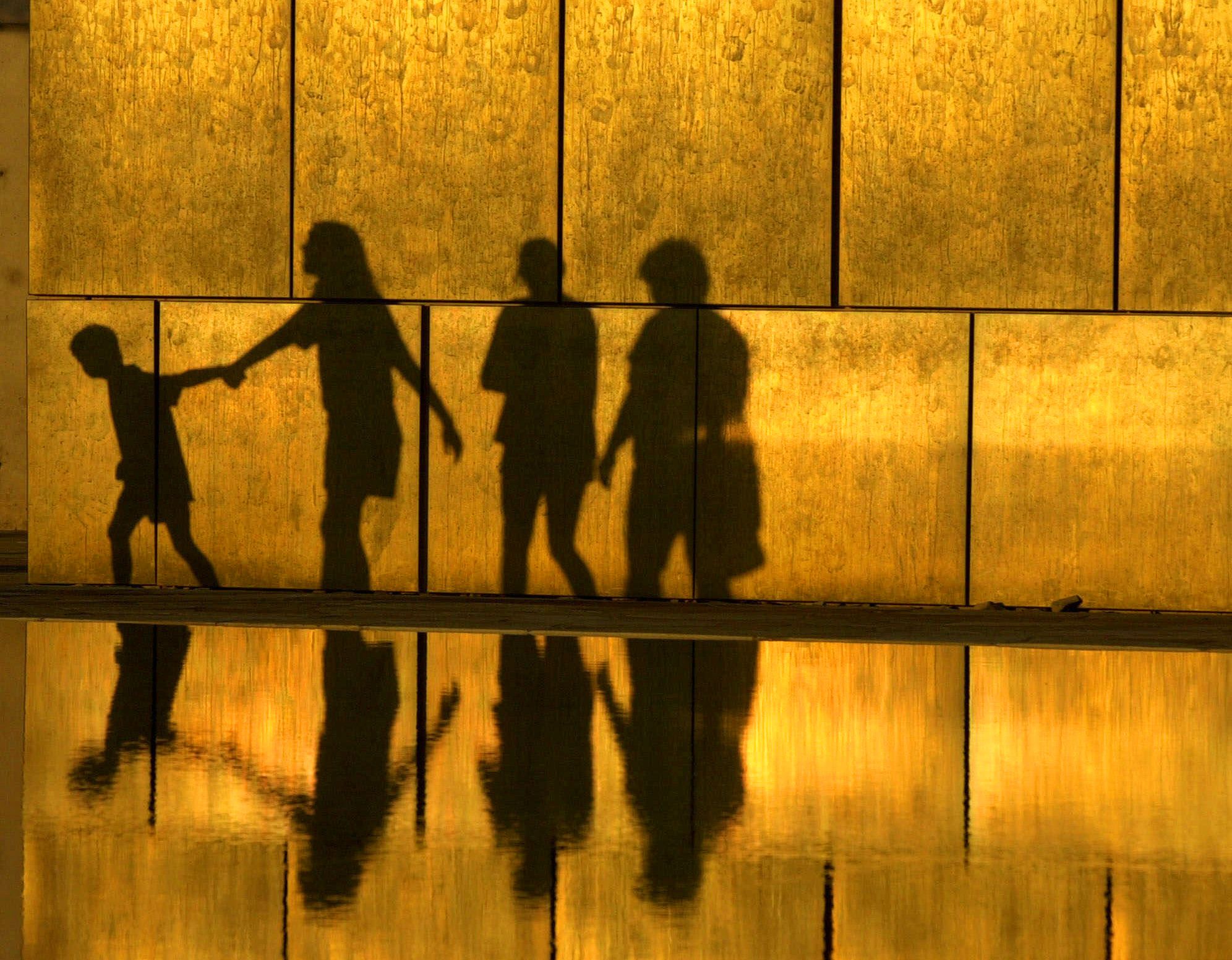 Visitors to the Oklahoma City National Memorial in Oklahoma City, are reflected against one of the Gates of Time and in the reflecting pool as the sun goes down  Sunday, June 10, 2001. The memorial is at the bombing site of the 1995 Alfred P. Murrah Federal Building bomb.  Convicted Oklahoma City bomber Timothy McVeigh was executed in Terre Haute, Ind., Monday, June 11, 2001. Visitors to the site sometimes place their hands in the water and then on the Gate of Time to leave their hand prints, shown above. Timothy McVeigh Execution Oklahoma City