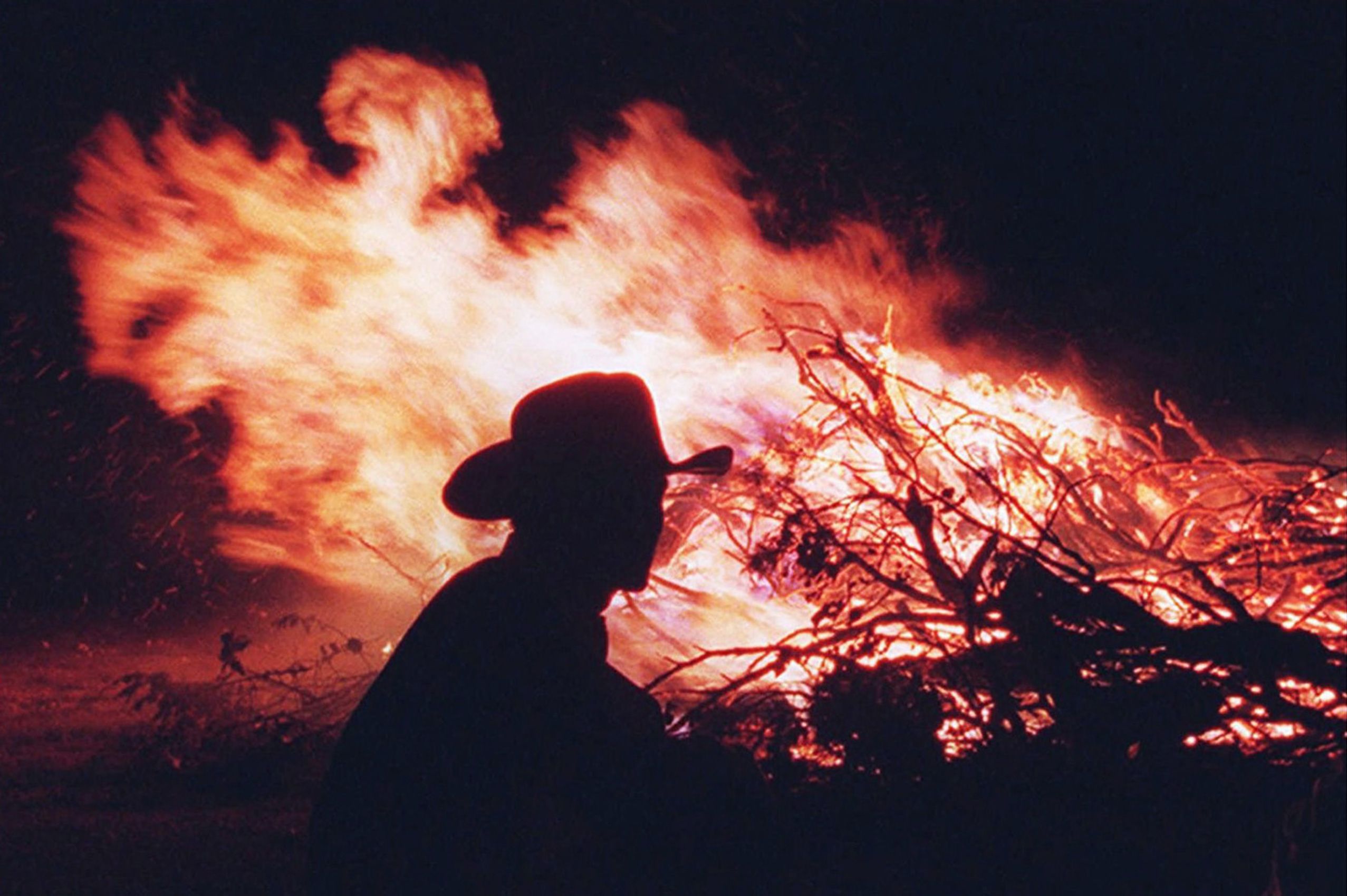 Rancher Steve Vestring burns brush at his ranch headquarters in Cassoday, Kan. in 1997.  Kansas Cowboys
