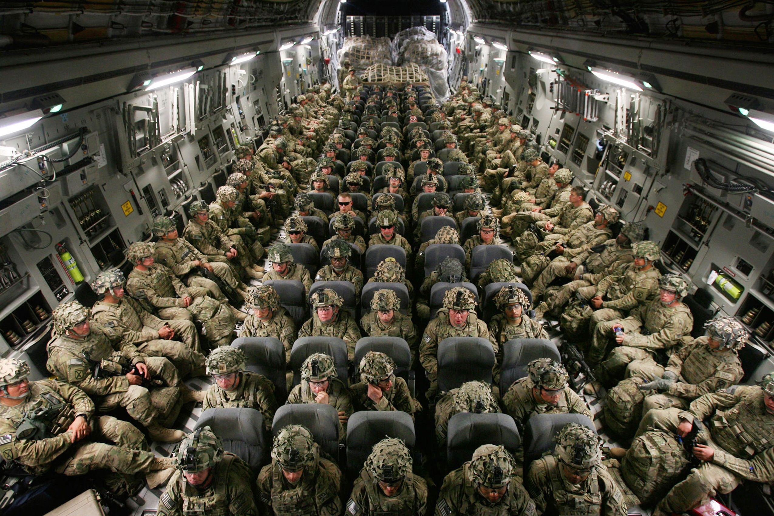 Soldiers with 3rd Brigade, 10th Mountain Division fly on a C-17 on their way to Manas Transit Center, Kyrgyzstan on March 3, 2012 on their way to Fort Drum, NY after a year deployment in Kandahar province, Afghanistan.  10th Mountain Division