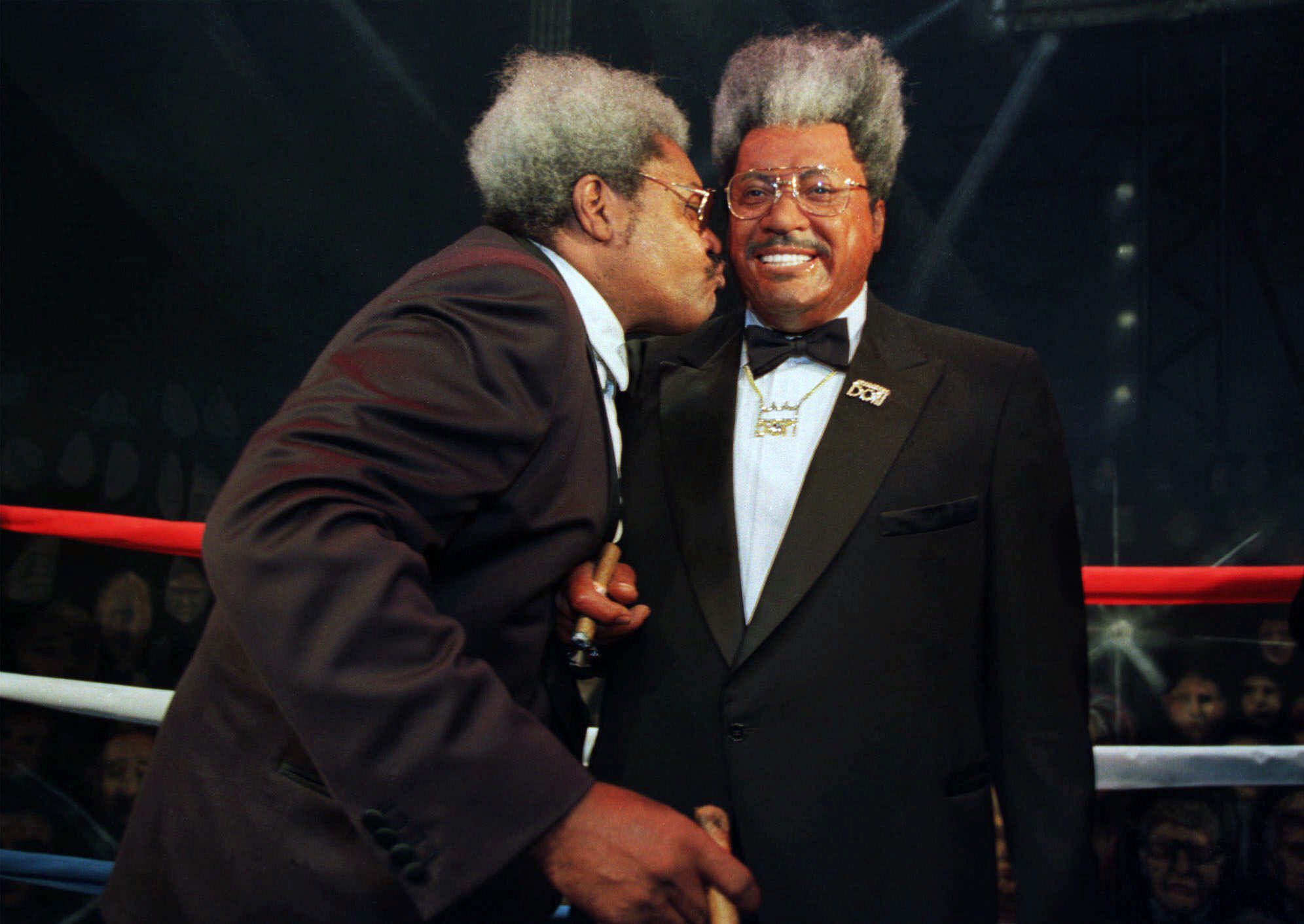 Boxing promoter Don King kisses his likeness during the grand opening of Madame Tussaud's Celebrity Encounter in Las Vegas, Thursday, July 22, 1999. The museum is the first Tussaud wax museum to open in America and expect to host 6 million people annually.  Don King Madame Tussaud's Las Vegas