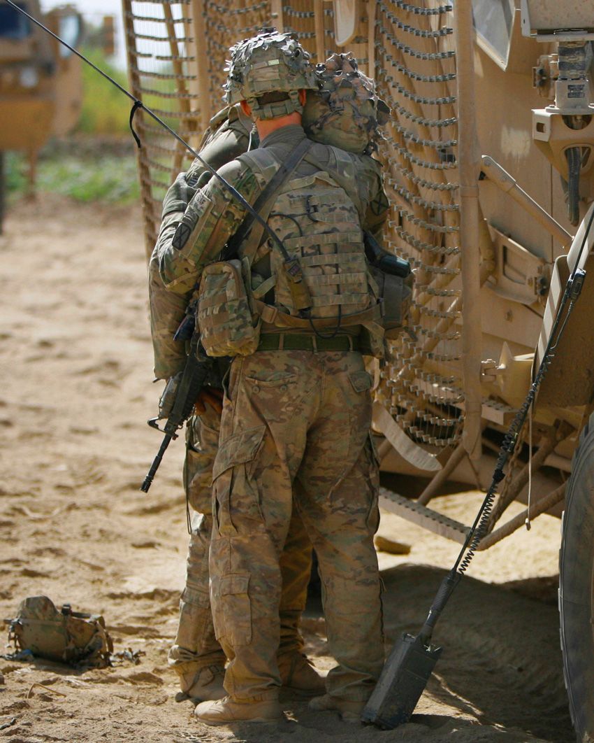 Company C Commander Capt. Dennis Call of 1st Battalion, 32nd Infantry Regiment, 3rd Brigade Combat Team, 10th Mountain Division, comforts Pfc. Jeffrey Lola following an improved explosive device strike that killed five soldiers near Combat Outpost Nalgham in Afghanistan on August 11, 2011. Lola was one of the first to arrive following the blast.  Combat Company Afghanistan
