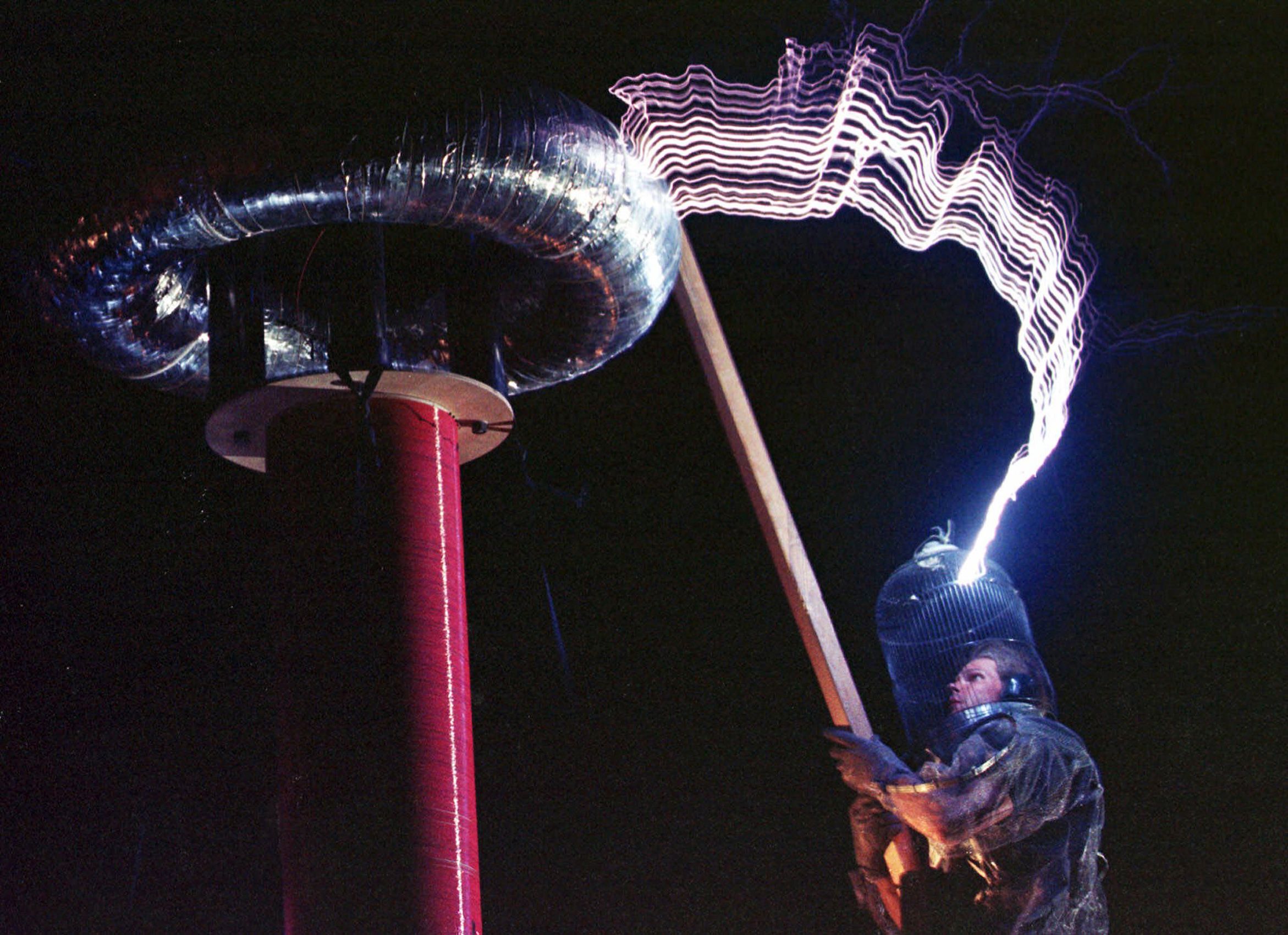 Austin Richards as Dr. Megavolt creates lightning bolts using a Tesla coil and a bird cage during the Burning Man festival in the Black Rock Desert near Gerlach, Nev., Thursday, Sept. 2, 1999. The gathering, intented to be a celebration of radical free expression and self reliance, will host 20,000 people before its culmination on Saturday with the torching of a 50-foot wooden man draped in fireworks and neon. Burning Man 1999