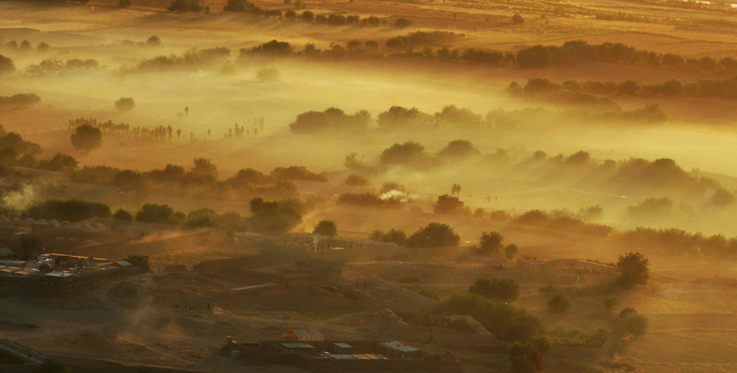 The Afghan landscape is seen as dusk as Air Force Pararescue helicopters fly near Camp Bastion, Afghanistan in Helmand province on June 9, 2012.  Helmand Afghanistan