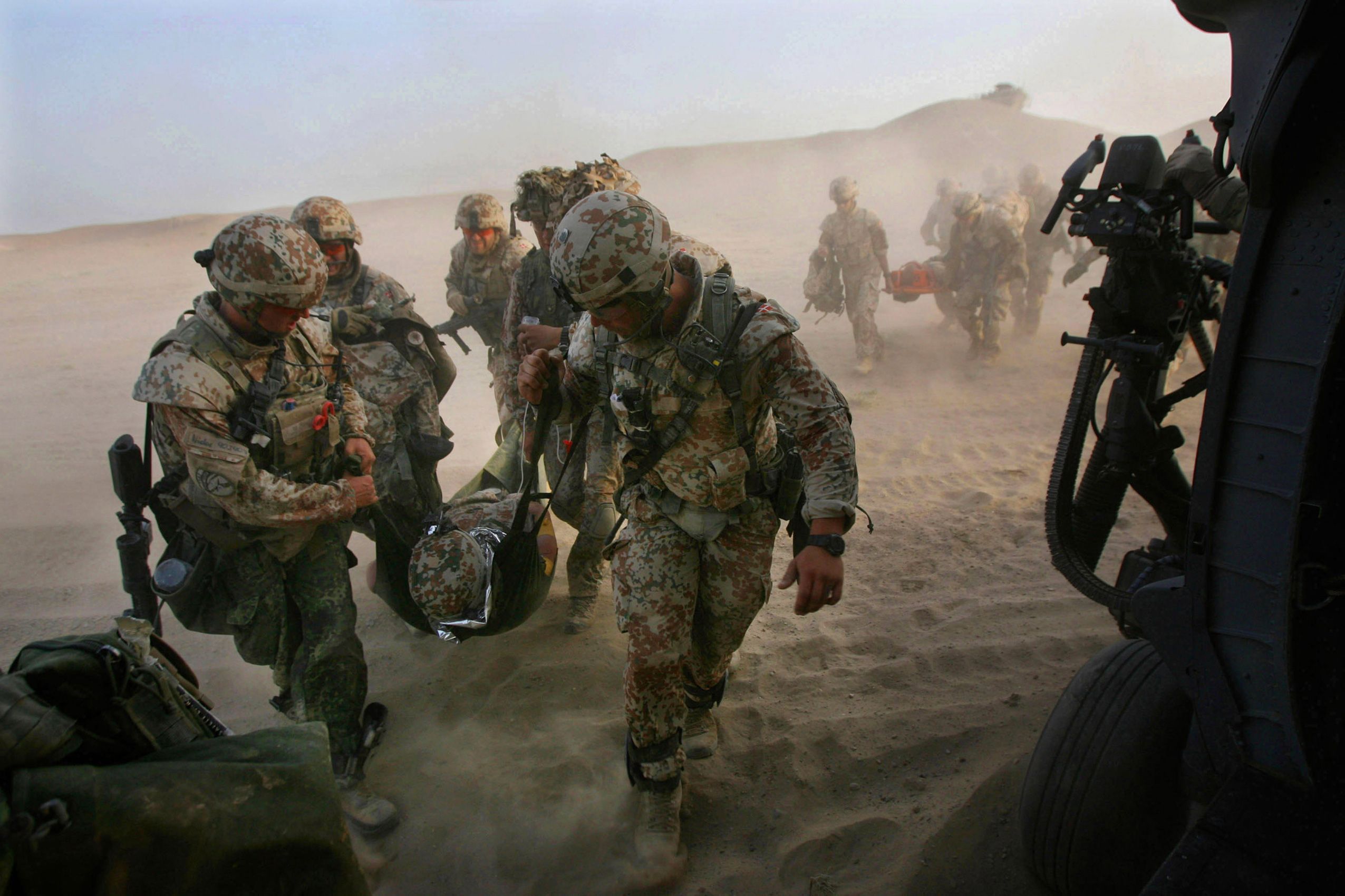 Danish troops carry a wounded soldier to an Air Force HH-60 Pave Hawk helicopter following an improvised explosive device attack in Helmand province, Afghanistan on June 20, 2012.  Air Force Pararescue