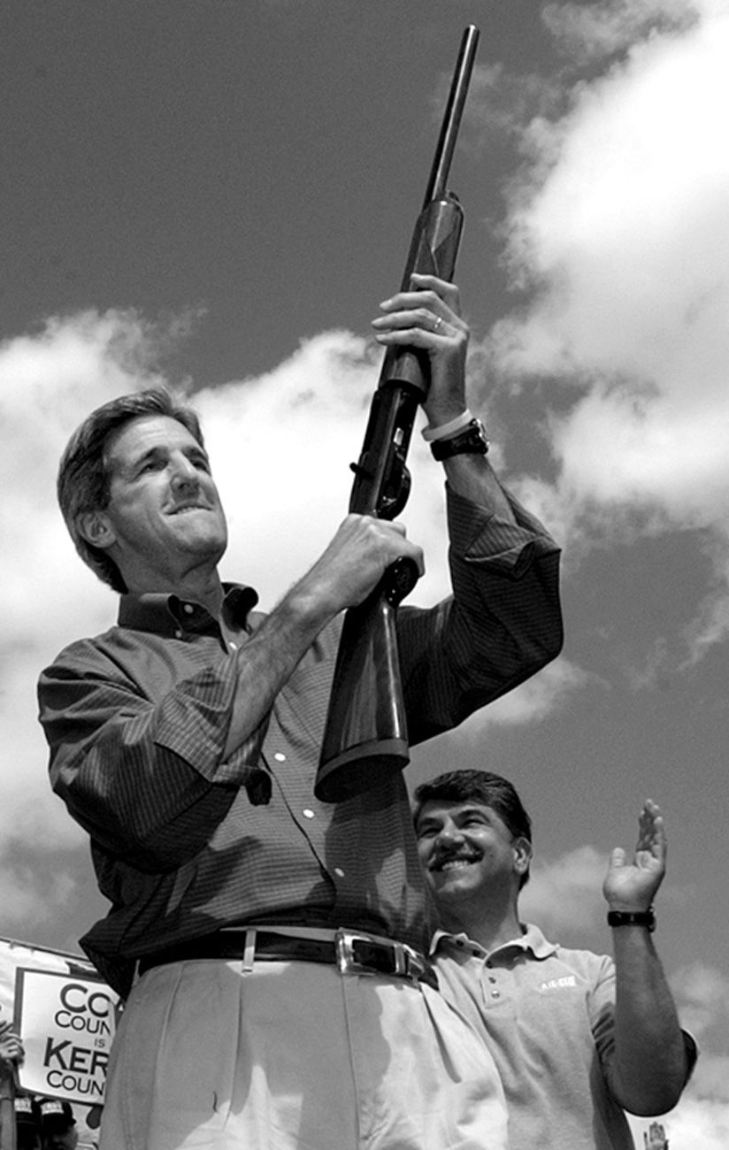 Democratic presidential nominee, Sen. John Kerry, D-Mass., holds up a shotgun he received as a gift while visiting a Labor Day celebration in Racine, West Virg. on Monday, Sept. 6, 2004.  John Kerry Presidential Campaign 2004