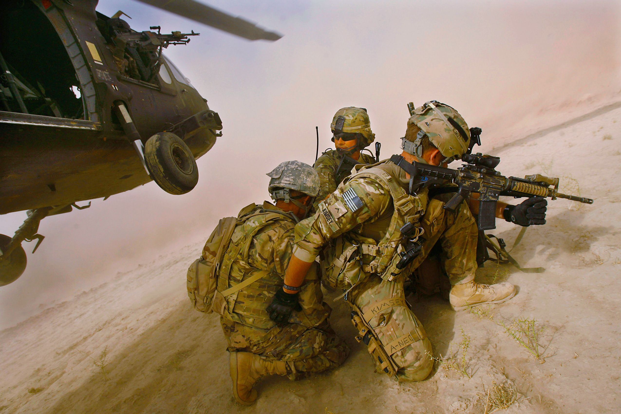 Sgt. 1st Class Joseph Zoellner, center, and Pfc. Joseph Kimsey, right, of Company F, 4th Battalion, 101st Aviation Regiment, 159th Combat Aviation Brigade, 101st Airborne Division, are dropped into the Registan Desert by Black Hawk helicopter for a mission south of Kandahar City, Afghanistan on October 5, 2011. Their Afghan translator, left, asked not to be identified for fear of Taliban reprisal.  101st Airborne Division Pathfinders