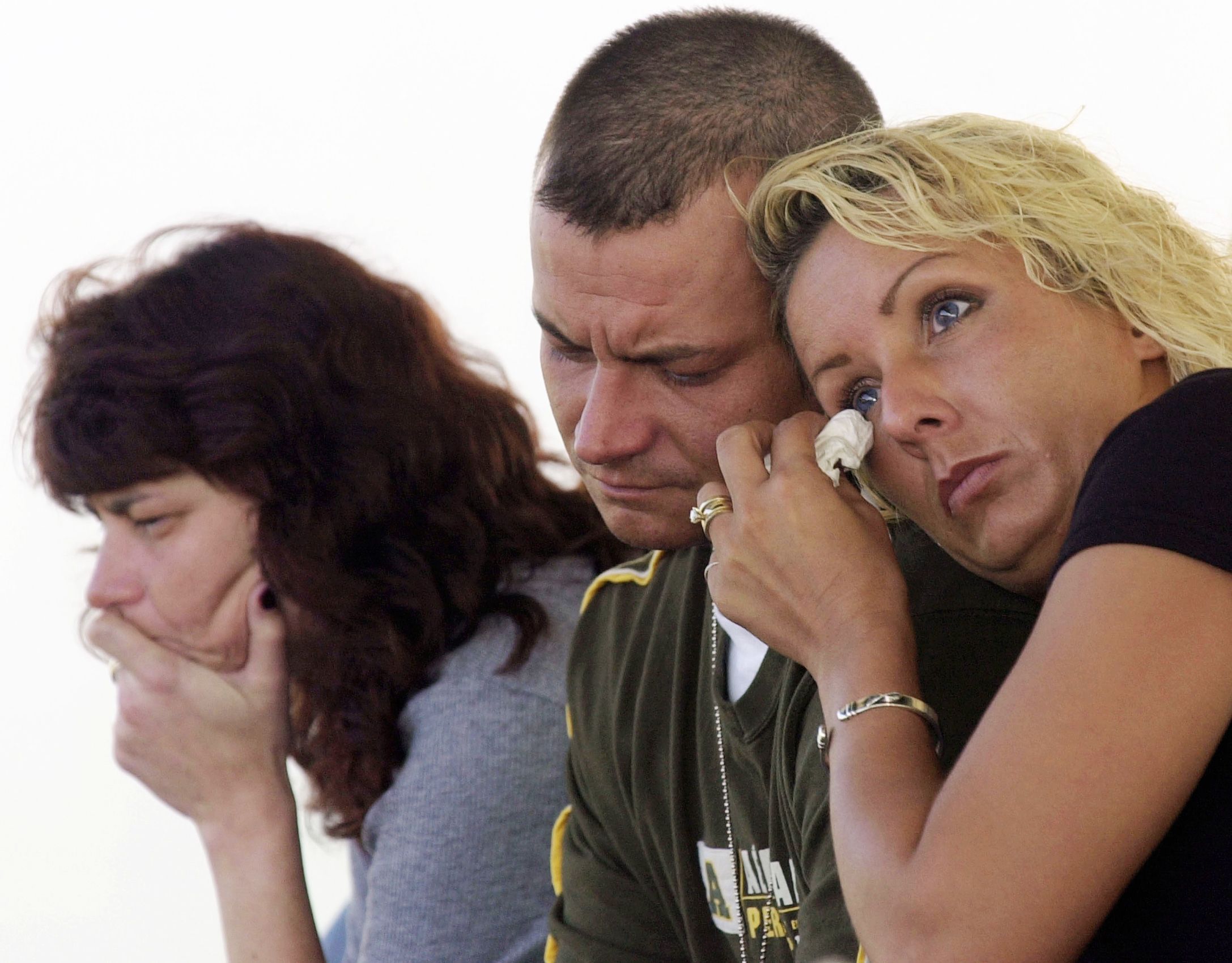 Execution Witnesses-Execution witnesses Shari Sawyer, right, wipes a tear as she leans on her husband Jay's shoulder in Oklahoma City following the execution of Timothy McVeigh on Monday, June 11, 2001. Jay Sawyer's mother was killed in the 1995 bombing of the Alfred P. Murrah Federal Building. The Sawyers were among nearly 300 people who witnessed the execution of McVeigh in Terre Haute, Ind. on closed-circuit television. At left is Dolore's daughter Mickey Sawyer.  Timothy McVeigh Execution Oklahoma City
