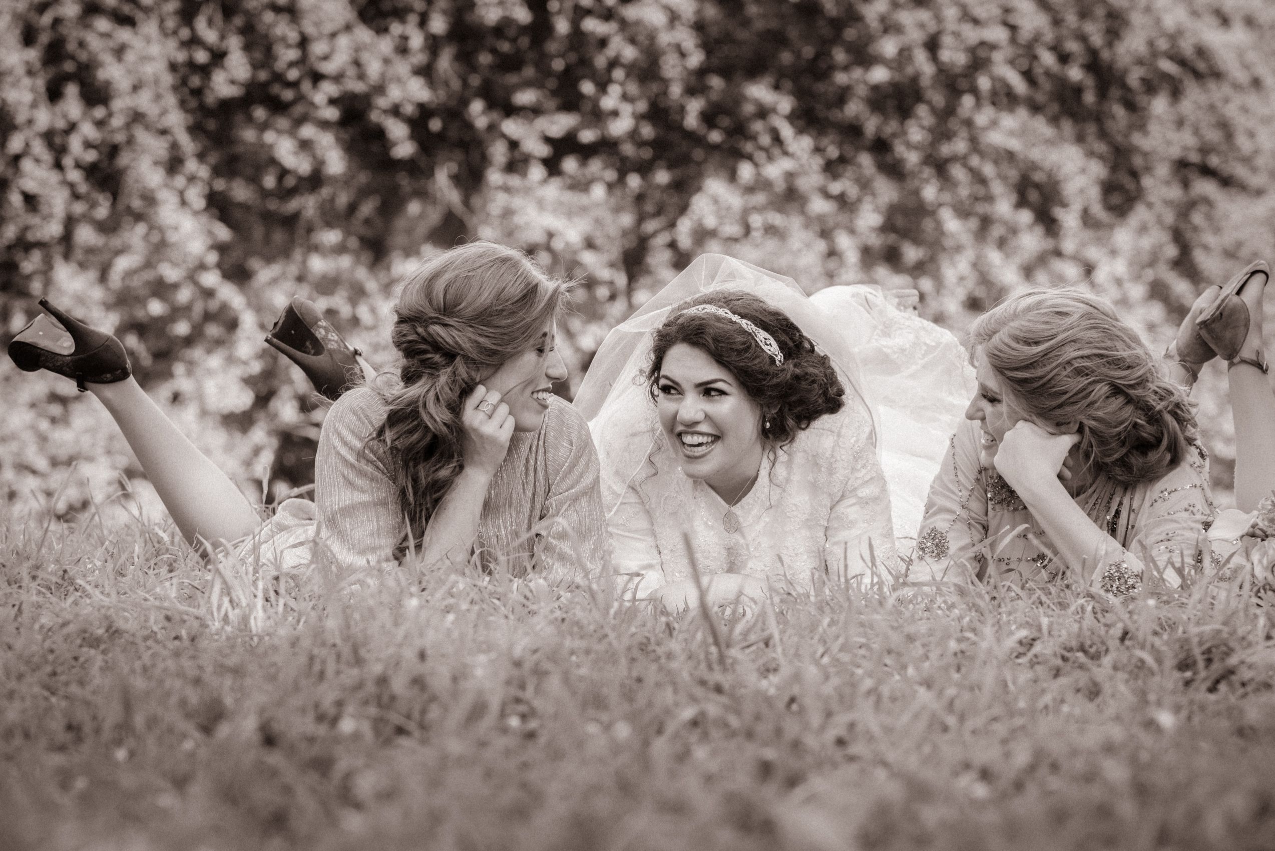 Heat Wave, Brooklyn NY, Bride and her sister take a break in the grass.