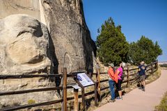 Visitors reading some of the signatures at El Morro National Monument Visitors at El Morro
