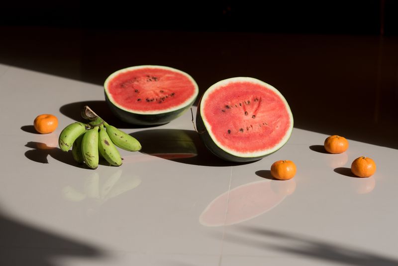 Watermelon and small bananas in a ray of morning sun, from Thai Fruit