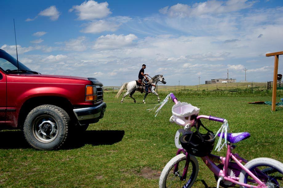Killing time in Browning, MT, an unemployed youth heads back home on his horse. Photographed for the New York Times. AFTERNOON RIDE