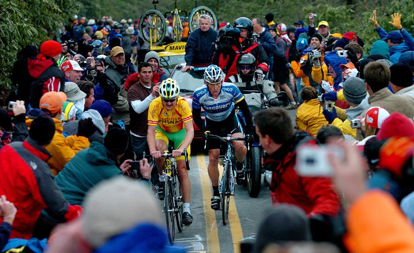 Professional cyclists Floyd Landis and Lance Armstrong battle it out as they charge through crowds up Brasstown Bald during the Tour de Georgia. FLOYD LANDIS AND LANCE ARMSTRONG