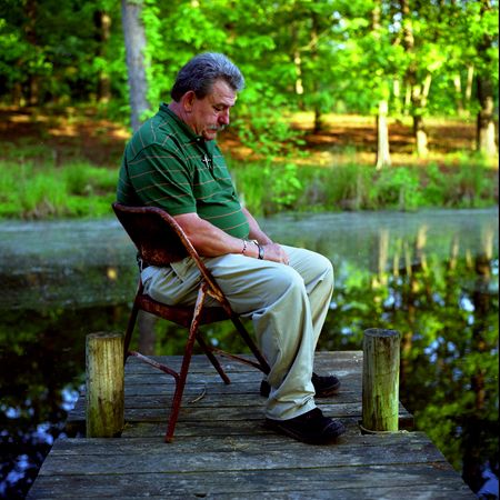 Jim Brunson, 54, the father of Spc. Jacques "Gus" Brunson, who was killed in Iraq as part of the deployment of the Georgia National Guard's 48th Brigade, contemplates his son's death on the dock of a pond near the home he rents in Bogart, GA. MOURNING SON KILLED IN IRAQ
