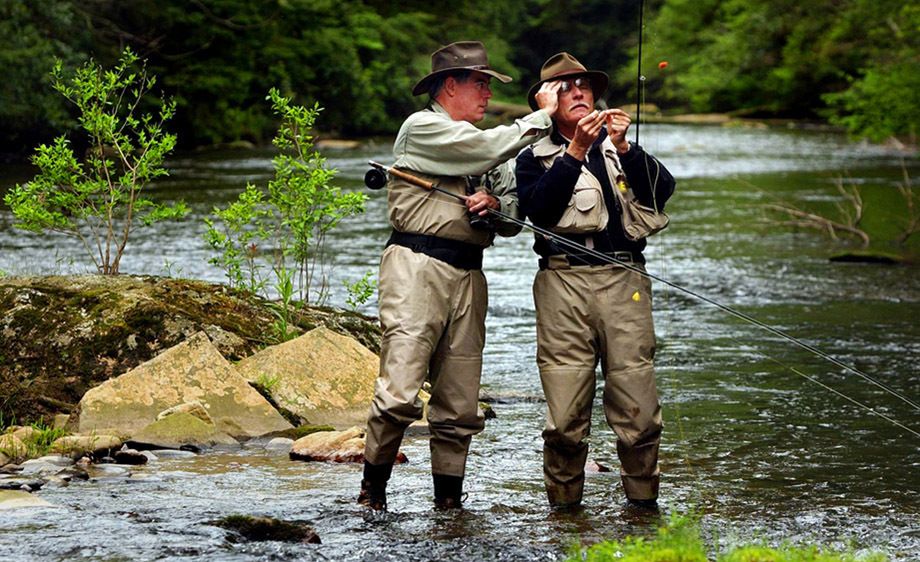 Billionaire, philanthropist, and media mogul Ted Turner gets visual assistance from his longtime adviser, Taylor Glover, while fly-fishing the Soque River in North Georgia. TED TURNER