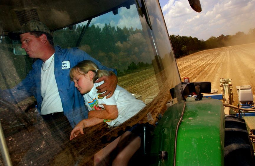 Seven-year-old Courtney Carter enjoys riding shotgun with her dad, Joel Carter, but says it often puts her to sleep. As an infant, if Courtney had trouble sleeping at night, Joel would often take her for a tractor ride to lull her to sleep. Joel is a fourth-generation farmer who farms approximately 2000 acres in south Georgia. SUMMER SLEEP