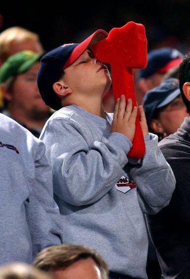A young Atlanta Braves fanatic seeks heavenly help during the National League Division Series. HEAVENLY HELP