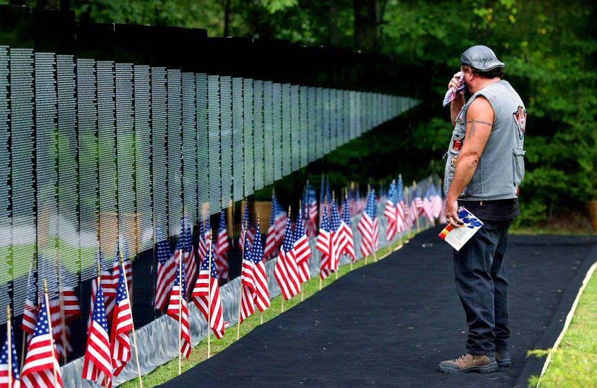 Vietnam veteran Larry Preston wipes away a tear while taking the in "The Moving Wall," a 252-foot replica of the Vietnam War Memorial in Washington D.C. THE MOVING WALL