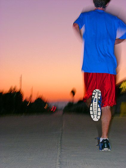 Male runner in Diesel shoes at sunset