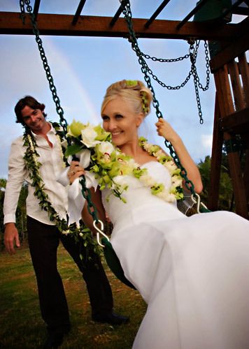 Hawaii Groom swings his Bride under the rainbow.