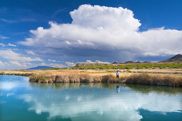 A fisherman beneath a building storm on a West Desert, Utah pond located in Salt Springs Waterfowl Management Area A Building Storm and Fisherman