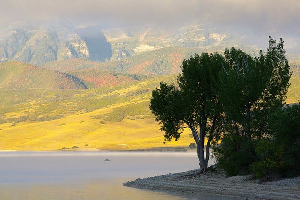 Fishing on Deer Creek State Park, Utah. Mount Timpanogos Wilderness in the background Deer Creek Morning