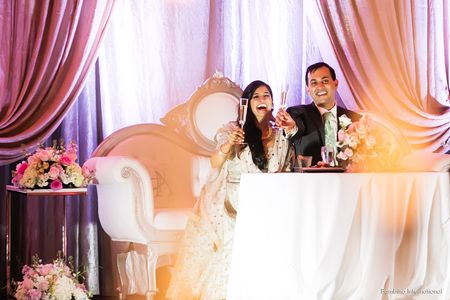 Indian wedding reception with custom backdrop and vintage furniture Indian wedding reception with custom backdrop and vintage furniture