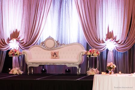 Indian wedding reception with custom backdrop and vintage furniture Indian wedding reception with custom backdrop and vintage furniture