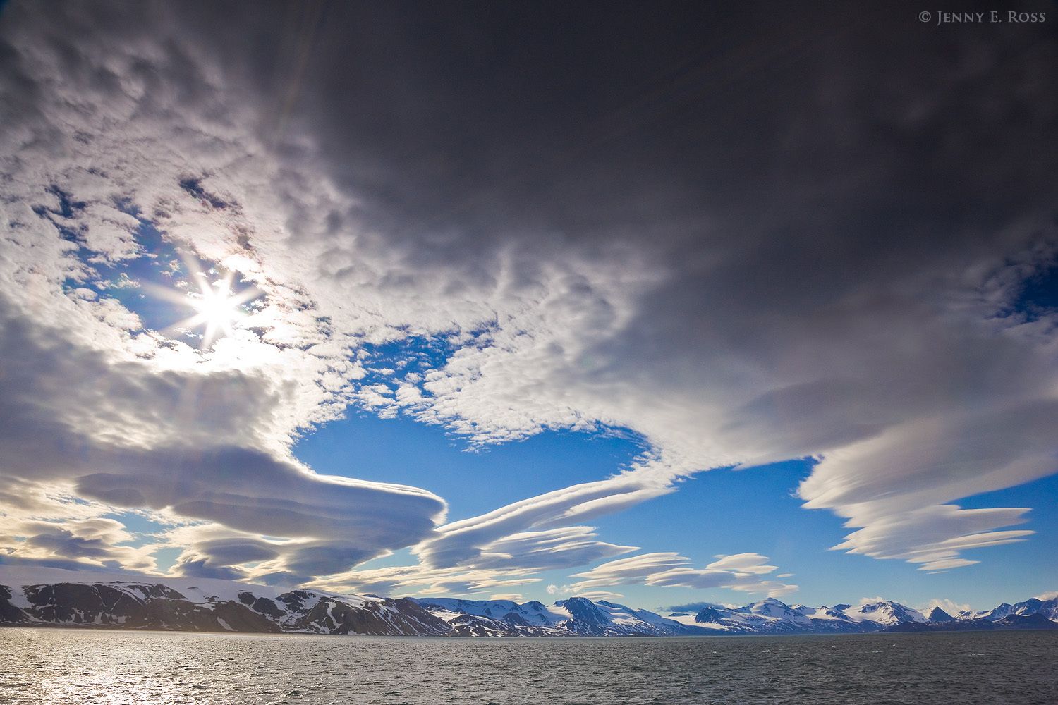 Formed by very strong high-elevation winds over mountain peaks, dramatic lenticular clouds soar above Hamiltonbukta in the northwest region of the island of Spitsbergen in the Svalbard Archipelago, Norway.
