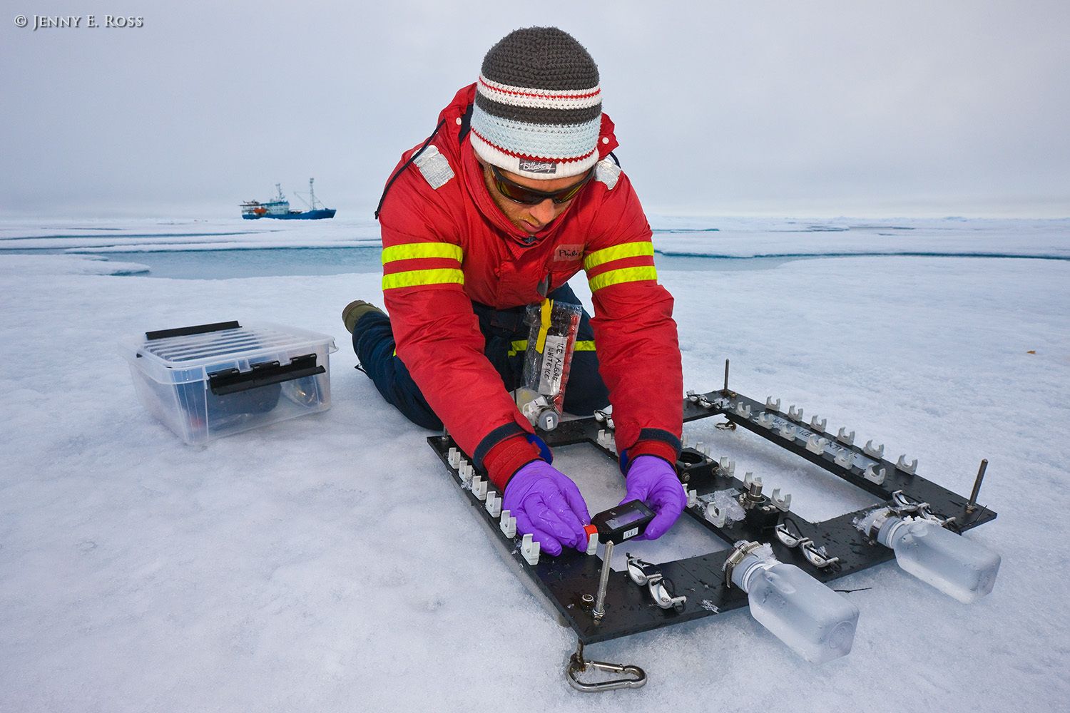 Dr. Philipp Assmy, a Norwegian Polar Institute biological oceanographer and plankton ecologist, prepares ice algae samples for analysis during an experiment involving timed incubation of the samples beneath a large floe of sea ice in the Arctic Ocean. The aim of the experiment was to assess biological productivity (i.e., ice-algae growth rates) under different ice types and thicknesses, and in varying light conditions. The samples were initially harvested from under the ice in this location, and then treated with a chemical marker which would enable Dr. Assmy to quantify subsequent growth rates. Ice algae are a crucial foundational component of the Arctic food chain, and are threatened by loss of sea ice due to climate change. This work was done during NPI's 2012 "ICE" (Ice, Climate, Ecosystems) expedition in July-August 2012. Scientific research on arctic sea ice, central polar basin, Arctic Ocean