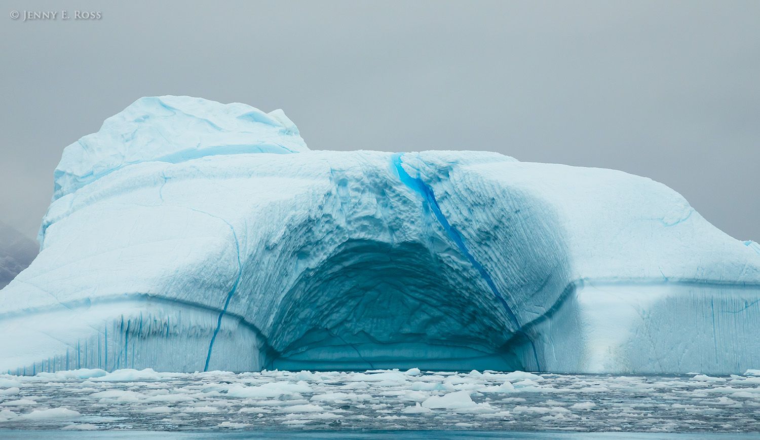 A huge arched iceberg near Gerard de Geer Glacier, in Isfjord within the Kejser Franz Joseph Fjord system, East Greenland National Park, Greenland.