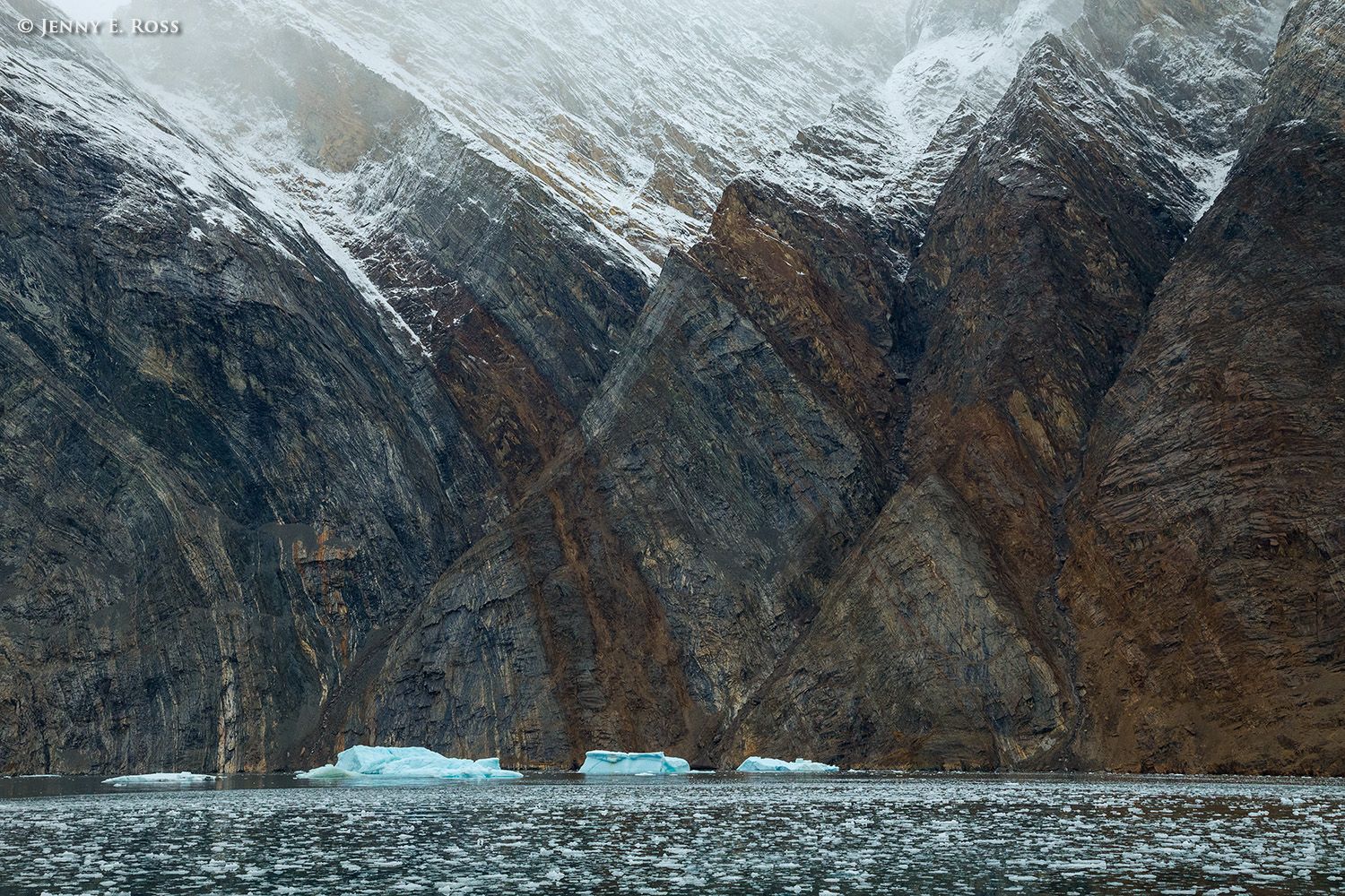 Ancient cliffs & icebergs in Kejser Franz Joseph Fjord System at Nordenskiold Glacier, Northeast Greenland National Park, Greenland.