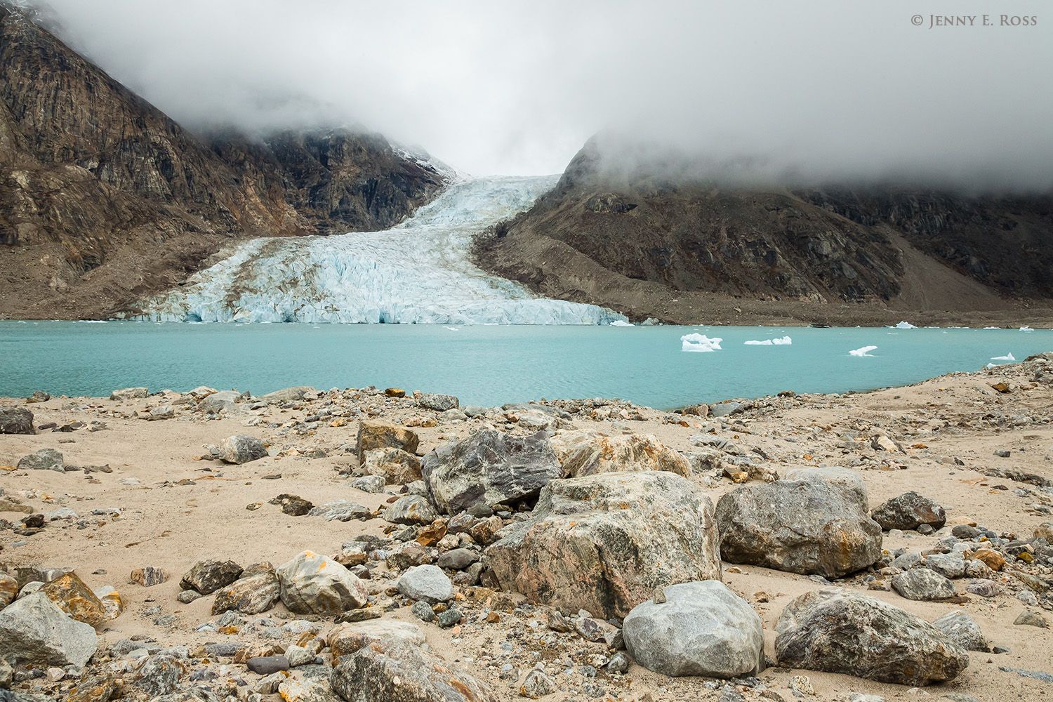 Boulders, gravel, and sand of a terminal moraine lie far from the receding glacier that left them behind in Alpefjord, Kong Oscar Fjord system, Northeast Greenland National Park, Greenland.