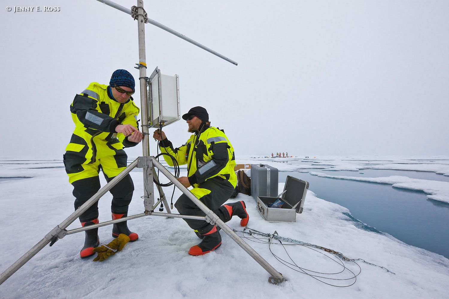 Norwegian Polar Institute scientists Dr. Mats Granskog and Dr. Stephen Hudson deploy research equipment on a large floe of sea ice in the Arctic Ocean during NPI's 2012 "ICE" (Ice, Climate, Ecosystems) expedition in July-August 2012. They are setting up a portable weather station that operated automatically and collected data throughout the expedition. Scientific research on arctic sea ice, central polar basin, Arctic Ocean